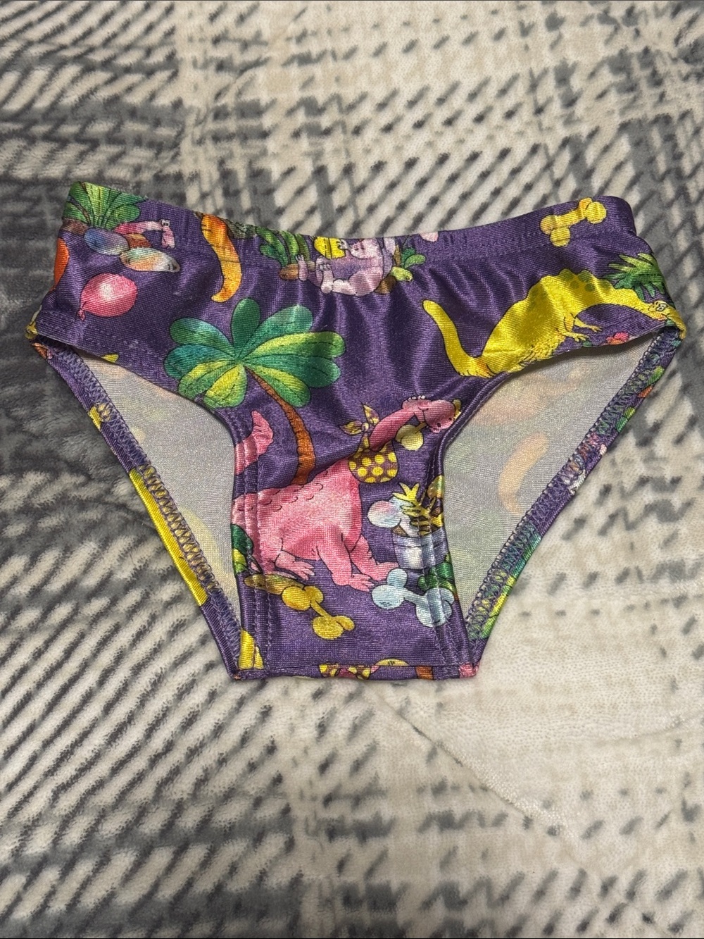 Girls' Purple Dinosaur Print Swim Briefs with Bright Jungle Motif